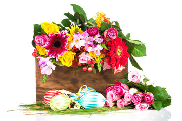 Easter eggs and flowers on white background