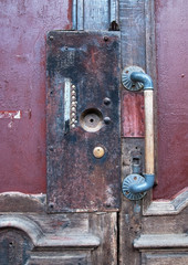 Old wooden door with flat buttons and vintage handle