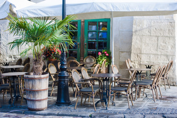 chairs on a cozy summer terrace. Italian cafe with coffee and sweets. exterior restaurant