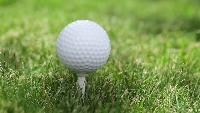Golfer putting a golf ball and strikes.