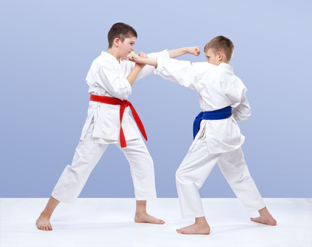 Two boys train strikes and blocks of hands