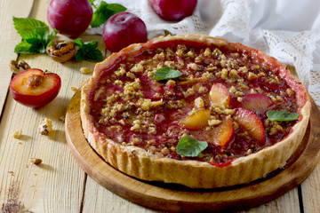 Plum cake shortbread dough with walnuts on a table in a rustic s