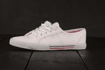 White sneakers from an aerial view on wooden