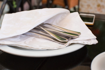 High Angle View of Silver Knife and Fork Tied with String and Blank Tag on White Napkin with...