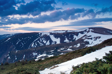 spring calm mountain landscape with lake covered ice