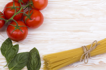 still life with pasta, fresh basil and tomatoes.