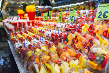 Fruit Salad arranged in plastic cups on a market