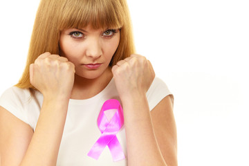 Fototapeta premium Woman wih pink cancer ribbon on chest punching