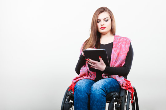 Disabled student with tablet ebook.