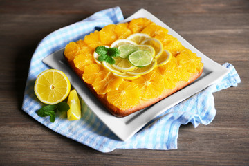 Delicious citrus cake on wooden background