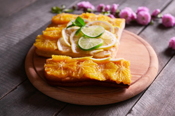 Delicious citrus cake on wooden background