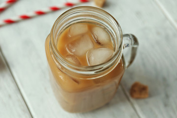 Iced coffee with milk on wooden background