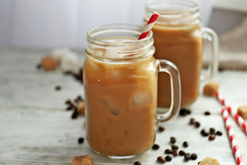Iced coffee with milk on wooden table