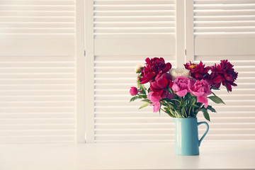 Beautiful peony flowers on white folding screen background