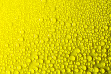 drop of water on yellow background(selective focus)