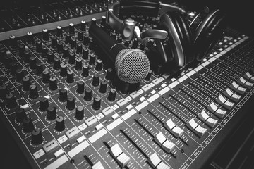 Music instruments the microphone and headphones on sound mixer.