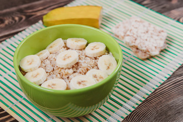 Tasty Oatmeal Porridge with Bananas in Green bowl