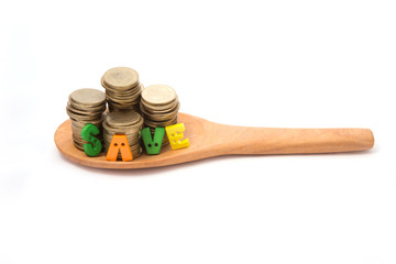 Coins (Five baht type) on wooden spoon