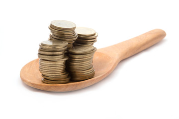 Coins (Five baht type) on wooden spoon