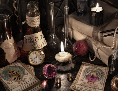 Close up of the tarot cards, magic books and candles