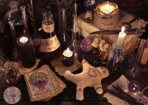 Mystic still life with voodoo doll, the tarot cards, witch books and magic objects