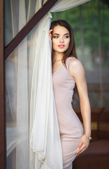 Fototapeta premium Beautiful girl in a sexy dress near the pool
