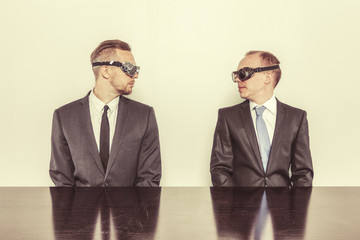 Two businessman sitting at office desk