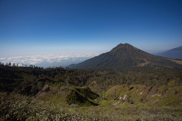 View from the tropical forest with path to the volcano Kawah Ije
