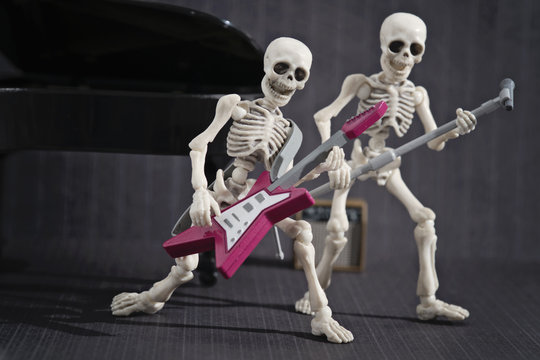 Two skeleton playing rock music
