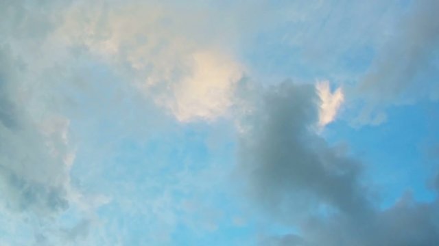 Unique, abstract shot of clouds in a grayscale spectrum, drifting in a blue sky, from the perspective of a rotating camera. Video FullHD