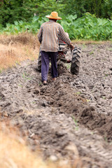 Farmers is working control pushcart to recondition soil crop.