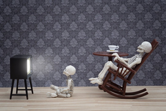 skeleton and little skeleton watching TV