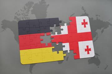 puzzle with the national flag of germany and georgia on a world map background.