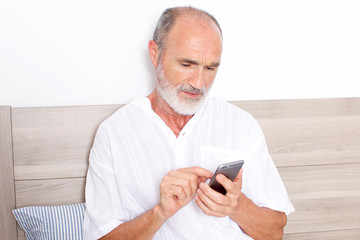 Elderly man using an app on phone 
