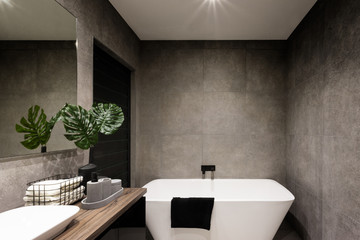 Modern bathroom wall made in dark color tiles - obrazy, fototapety, plakaty