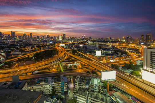 The traffic jam on expressways of Bangkok city with colorful sky twilight, tilt-shift blur effect