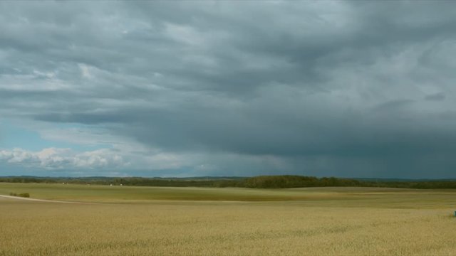 WIDE LR PAN shot of a rural landscape on a rainy day 
