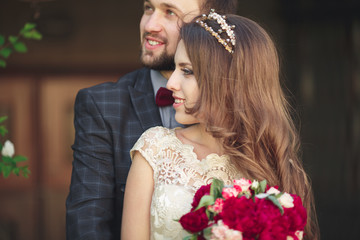 Kissing wedding couple in spring nature close-up portrait