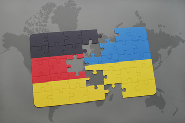 puzzle with the national flag of germany and ukraine on a world map background.