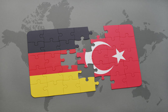 puzzle with the national flag of germany and turkey on a world map background.