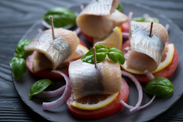 Close-up of canapes with herring fillet, selective focus