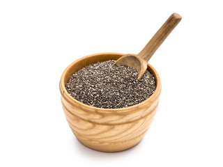 Chia seeds in a wooden bowl with a wooden spoon in it on a white background