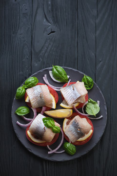 Top View Of Canapes With Herring On A Black Wooden Surface