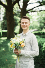 Man, groom posing with perfect wedding bouquet