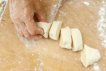 hands of the confectioner cut dough