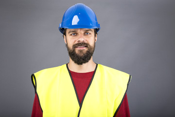 Closeup portrait of a confident engineer with blue hard hat