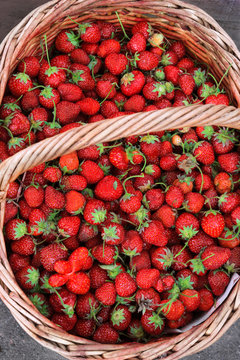 Fresh strawberry in wooden  basket. Top view, high resolution product.
