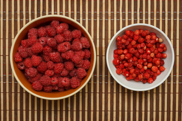 Ripe raspberries and strawberries on my plate. The view from the top.