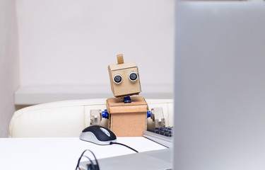 the robot is busy working on the computer