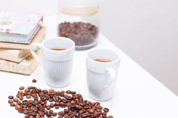Naklejka premium Two white cups of coffee are on the table